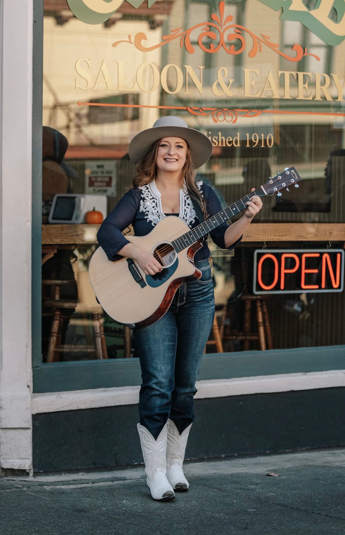 Kitty Mae leaning with guitar