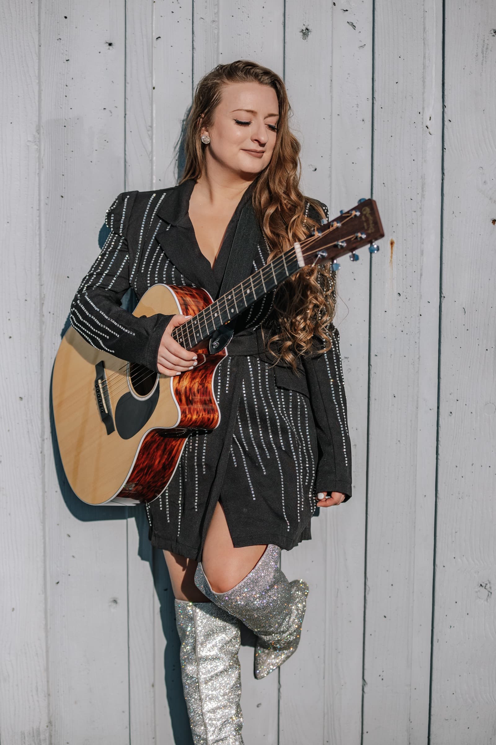 Kitty Mae with guitar on gazebo