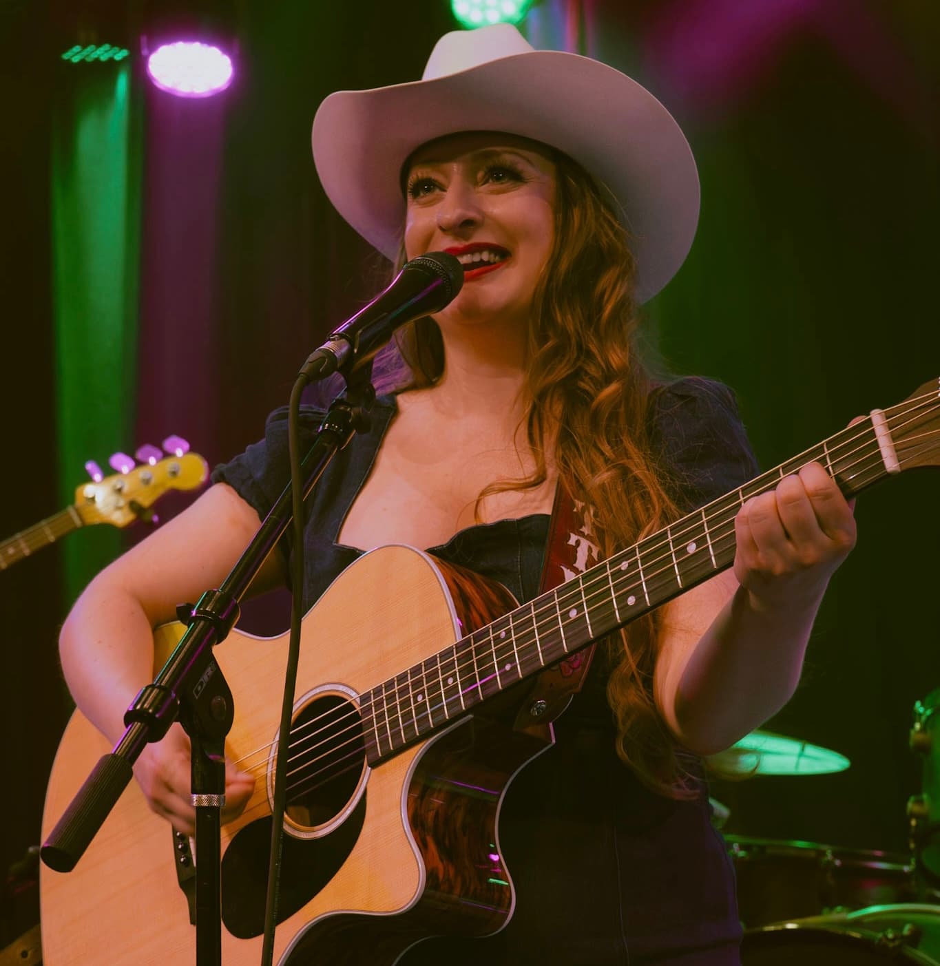 Kitty Mae singing live with guitar